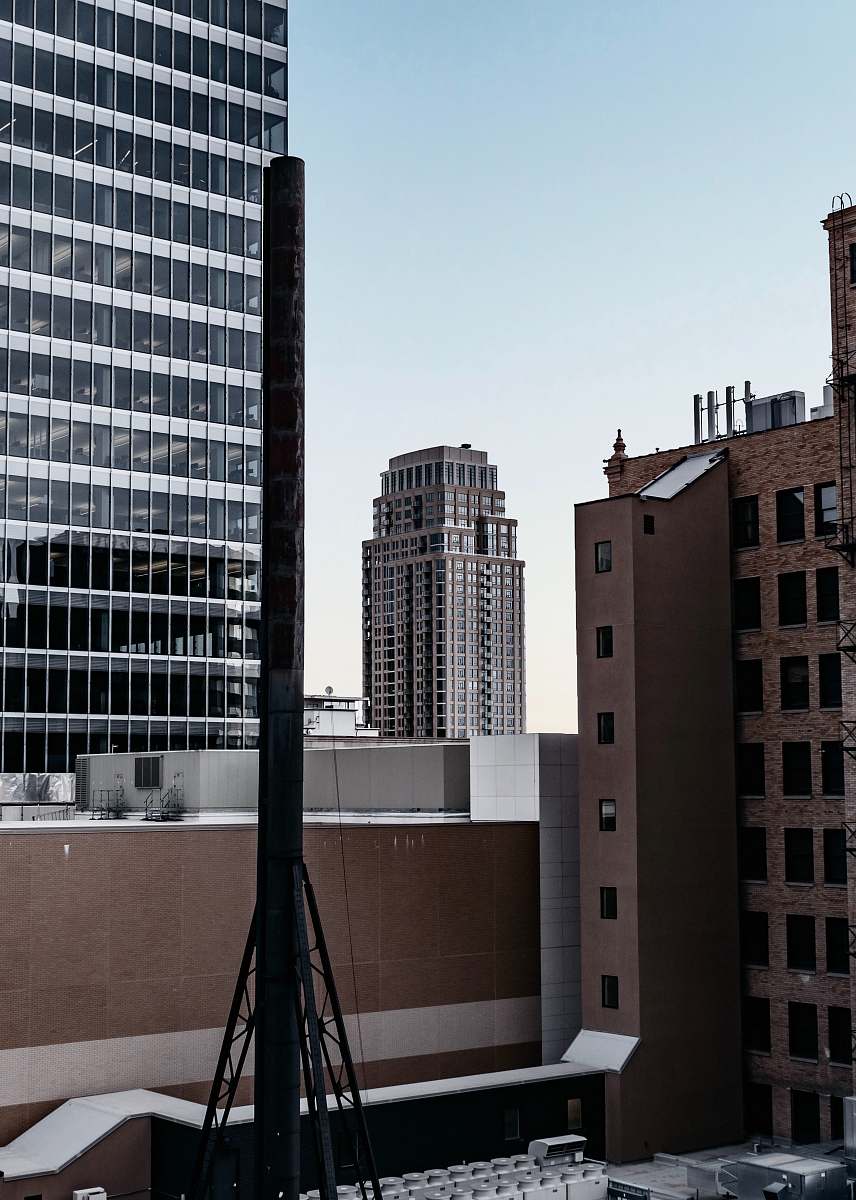 office building selective focus photography of black metal post during daytime city